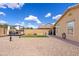 Large backyard featuring artificial turf, a stone landscaping, and a covered pergola at 1462 E Poncho Ln, San Tan Valley, AZ 85143