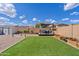 Spacious backyard with lush artificial turf, a shed, and a charming pergola-covered seating area at 1462 E Poncho Ln, San Tan Valley, AZ 85143