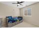 Bedroom with a bed that has built-in drawers, ceiling fan, and a window bringing in natural light at 1462 E Poncho Ln, San Tan Valley, AZ 85143