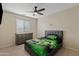 Cozy bedroom with a ceiling fan, a window with blinds, a grey dresser, and a racecar themed bed at 1462 E Poncho Ln, San Tan Valley, AZ 85143