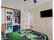 Comfortable bedroom with an open closet, a TV, and racecar themed bedspreads at 1462 E Poncho Ln, San Tan Valley, AZ 85143