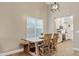 Cozy dining room with a rustic wooden table, seating for four, and ample natural light at 1462 E Poncho Ln, San Tan Valley, AZ 85143