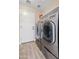 Efficient laundry room with modern washer and dryer, plus convenient shelving and storage at 1462 E Poncho Ln, San Tan Valley, AZ 85143