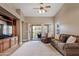 Inviting living room with a plush sofa, entertainment center, and access to the backyard at 1462 E Poncho Ln, San Tan Valley, AZ 85143