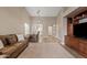 Spacious living room boasts high ceilings, light-colored walls, wood-look floors, and an adjacent dining area at 1462 E Poncho Ln, San Tan Valley, AZ 85143