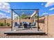 Stylish pergola-covered seating area, an inviting spot for outdoor relaxation and entertaining at 1462 E Poncho Ln, San Tan Valley, AZ 85143