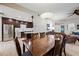 Spacious dining area adjacent to kitchen with wood table, chairs, and unique pendant lighting at 15380 N 100Th St # 1124, Scottsdale, AZ 85260