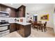 Stylish kitchen with stainless appliances and an island flowing into the dining and living area at 15380 N 100Th St # 1124, Scottsdale, AZ 85260