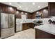 Modern kitchen features stainless steel appliances, dark cabinetry, and bright, tiled backsplash at 15380 N 100Th St # 1124, Scottsdale, AZ 85260