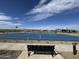 View of a blue basketball court with benches on the side, set against a backdrop of mountains and blue skies at 15510 W Deanne Dr, Waddell, AZ 85355