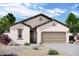 Charming single-story home with neutral stucco, tile roof, desert landscaping, and an attached two-car garage at 15510 W Deanne Dr, Waddell, AZ 85355