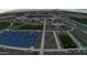 Aerial view of community park, showcasing basketball court, playground, green spaces, and picnic areas at 15644 W Deanne Dr, Waddell, AZ 85355