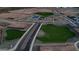 Community aerial view shows a playground, green spaces, basketball court, and residential area at 15644 W Deanne Dr, Waddell, AZ 85355