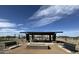 Community gathering spot with a shaded picnic area, benches, and verdant surroundings at 15644 W Deanne Dr, Waddell, AZ 85355