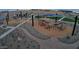 Playground view showcasing play structures, wood chip ground cover, and landscaped walking paths at 15644 W Deanne Dr, Waddell, AZ 85355