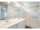 Bright, modern bathroom featuring a double sink vanity and glass-enclosed shower at 16017 N 19Th Dr, Phoenix, AZ 85023