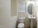 Clean powder room featuring a pedestal sink, oval mirror, and tiled floors with window and blinds at 16017 N 19Th Dr, Phoenix, AZ 85023