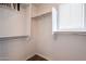 Bright, walk-in closet with a window and built in shelving at 16017 N 19Th Dr, Phoenix, AZ 85023