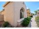 Exterior view of the house showcases a beige stucco wall and desert landscaping along the sidewalk at 16017 N 19Th Dr, Phoenix, AZ 85023