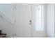 Interior view of the white front door with a window to the right and a stairwell to the left at 16017 N 19Th Dr, Phoenix, AZ 85023