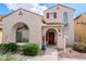 Inviting home exterior showcases a red-tile roof, stucco facade, arched window, and well-manicured landscaping at 16017 N 19Th Dr, Phoenix, AZ 85023