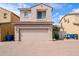 Charming two-story home featuring a large garage, beautiful brick driveway, and classic desert landscape at 16017 N 19Th Dr, Phoenix, AZ 85023