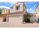 Angle view of a two-story home featuring a large garage, desert landscape, and adjacent home at 16017 N 19Th Dr, Phoenix, AZ 85023