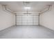 Spacious garage with a white door and gray epoxy floor at 16017 N 19Th Dr, Phoenix, AZ 85023