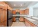 Bright kitchen featuring stainless steel appliances, wood cabinetry, and tile flooring at 16017 N 19Th Dr, Phoenix, AZ 85023