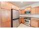 Large kitchen boasts a stainless steel refrigerator and other appliances paired with light wood cabinetry at 16017 N 19Th Dr, Phoenix, AZ 85023