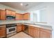 Spacious kitchen featuring stainless steel appliances, wood cabinets, and an open design concept at 16017 N 19Th Dr, Phoenix, AZ 85023