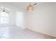 Open-concept living area showcases tile flooring, a modern light fixture, and neutral-colored walls at 16017 N 19Th Dr, Phoenix, AZ 85023