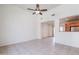 Bright living room with tile flooring, ceiling fan, and open layout connected to the kitchen at 16017 N 19Th Dr, Phoenix, AZ 85023