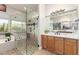 Bathroom with double vanity, quartz countertop, shower with glass door, and soaking tub at 16201 S 29Th Ave, Phoenix, AZ 85045