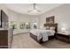 Bedroom featuring a large bed, neutral walls, two windows and a dresser and a TV at 16201 S 29Th Ave, Phoenix, AZ 85045