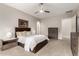 Bedroom featuring a large bed, neutral walls, ceiling fan, two side tables with lamps and a dresser at 16201 S 29Th Ave, Phoenix, AZ 85045