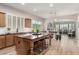 Spacious kitchen featuring a large island, wood floors, white subway tile backsplash, and stainless steel appliances at 16201 S 29Th Ave, Phoenix, AZ 85045