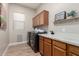 Functional laundry room with modern appliances, ample cabinetry, and stylish decor at 16201 S 29Th Ave, Phoenix, AZ 85045