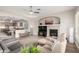 Open-concept living area flowing into a modern kitchen with a fireplace and ample natural light at 16201 S 29Th Ave, Phoenix, AZ 85045
