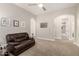 Cozy living room featuring plush brown leather seating and decorative artwork on the walls at 16201 S 29Th Ave, Phoenix, AZ 85045