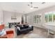 Open-concept living room featuring a piano, modern furniture, and an adjacent dining area with abundant natural light at 16201 S 29Th Ave, Phoenix, AZ 85045