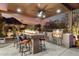 Covered outdoor kitchen features a built-in grill, beverage refrigerator, and countertop with bar seating and mountain views at 16201 S 29Th Ave, Phoenix, AZ 85045