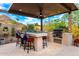 Outdoor kitchen and bar area with mountain views and seating at 16201 S 29Th Ave, Phoenix, AZ 85045