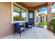 Inviting outdoor patio with tiled floors, comfortable seating, and serene views of the well-manicured backyard at 16201 S 29Th Ave, Phoenix, AZ 85045