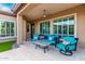Covered patio area with comfortable seating and a ceiling fan, ideal for enjoying the outdoors in any weather at 16201 S 29Th Ave, Phoenix, AZ 85045
