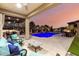 Inviting outdoor living space featuring a dazzling pool, covered patio, and built-in bar with picturesque sunset views at 16201 S 29Th Ave, Phoenix, AZ 85045