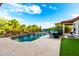 Stunning pool with a rock waterfall feature, surrounded by lush landscaping and plenty of room for entertaining at 16201 S 29Th Ave, Phoenix, AZ 85045