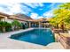Expansive backyard with a large pool, waterfall, and outdoor living space, perfect for relaxation and recreation at 16201 S 29Th Ave, Phoenix, AZ 85045