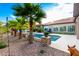 Resort-style pool area with palm trees, rock features, and comfortable seating, creating a tranquil retreat at 16201 S 29Th Ave, Phoenix, AZ 85045