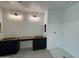 This picture shows a bathroom with black cabinets and a shower with white surround at 1913 W Lariat Ln, Phoenix, AZ 85085